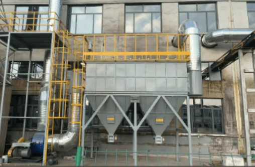 Industrial dust collection equipment installed near a workshop building